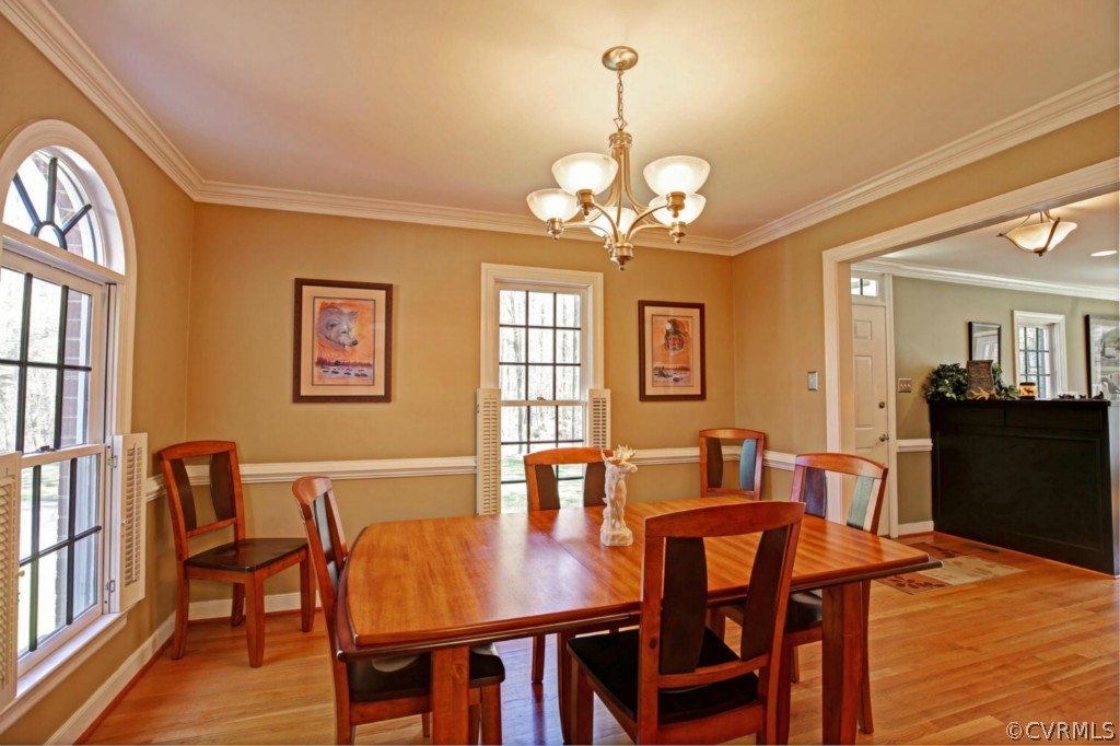 12200 Nash Road Chesterfield, VA 23838 - Photo 5 of 24 a view of a dining room with furniture a chandelier and wooden floor