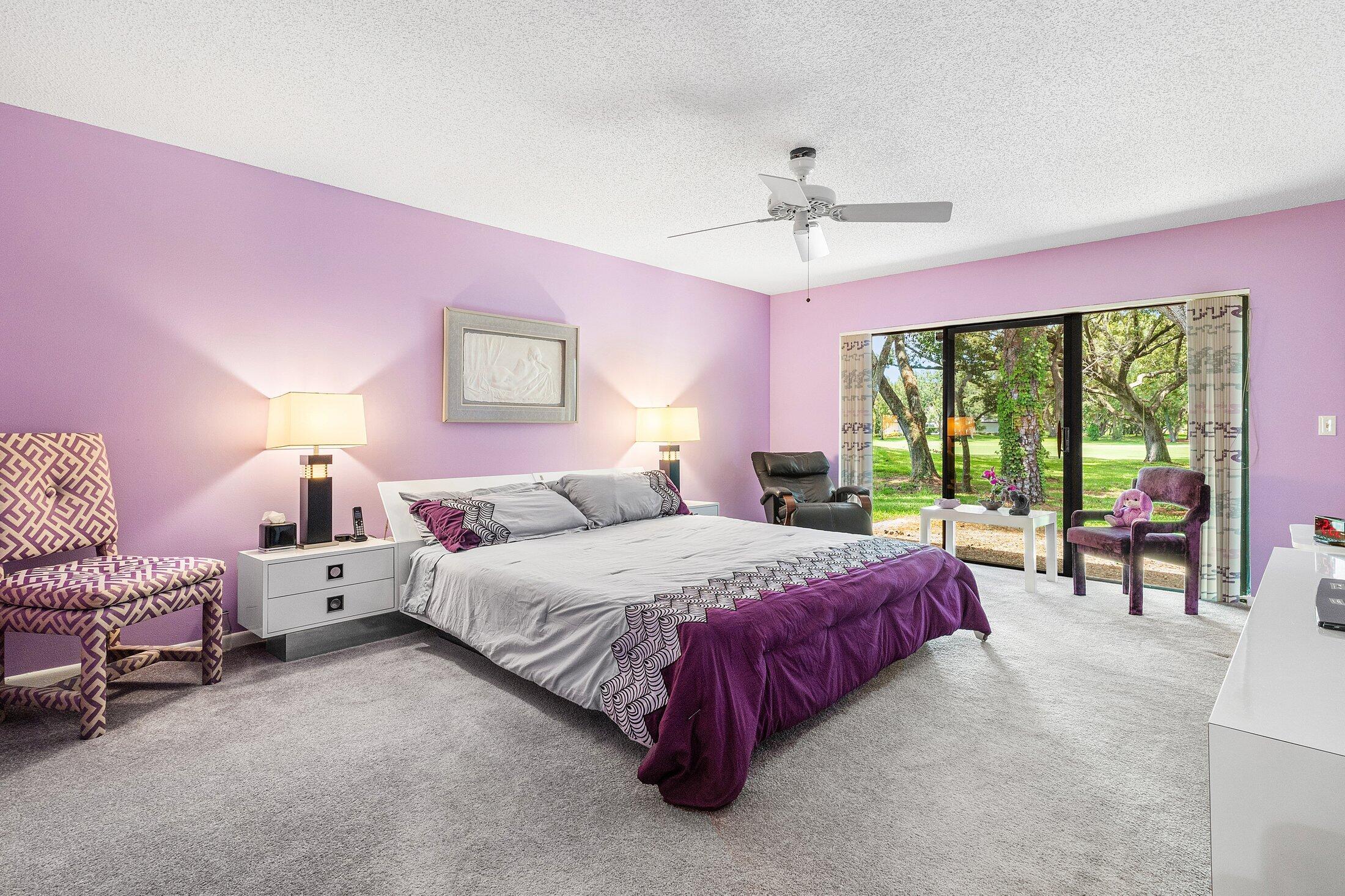 56 Woods Lane Boynton Beach, FL 33436 - Photo 22 of 77 a spacious bedroom with a bed and large windows