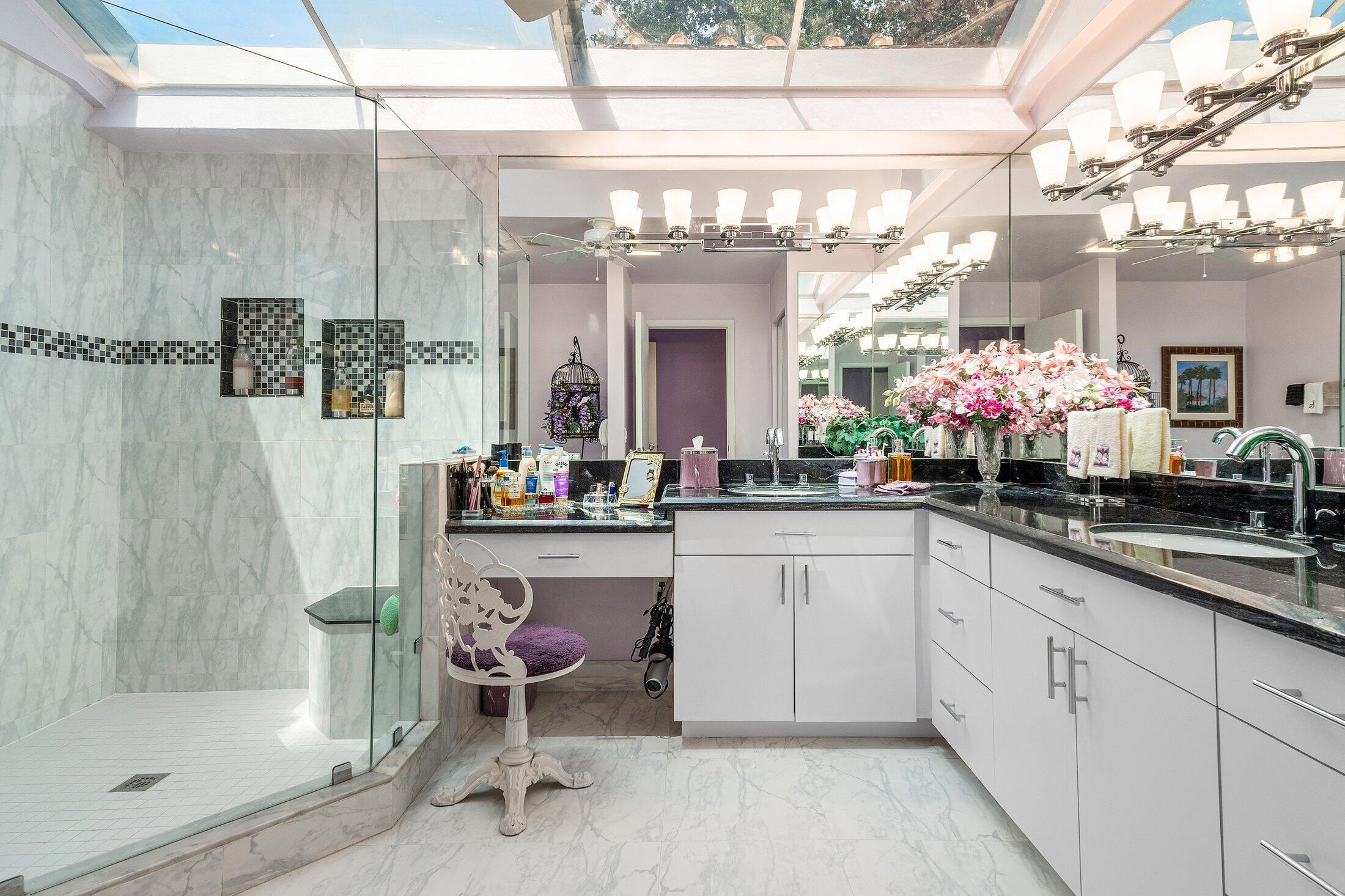 56 Woods Lane Boynton Beach, FL 33436 - Photo 25 of 77 a bathroom with a sink a mirror and a shower