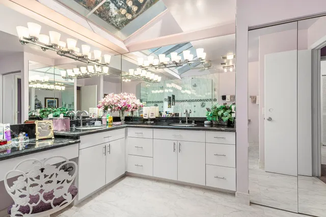 a view of house with wooden deck and furniture