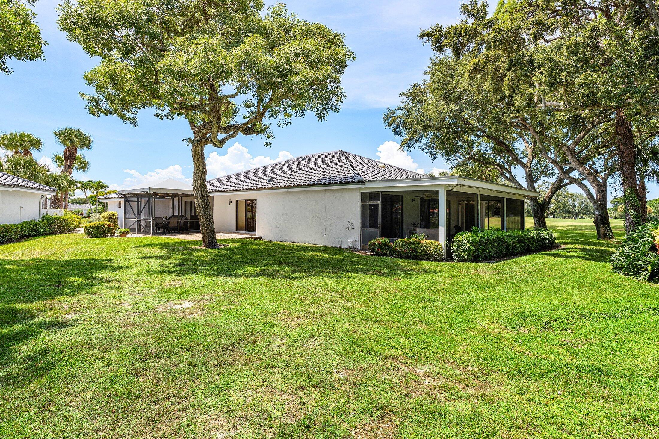 56 Woods Lane Boynton Beach, FL 33436 - Photo 40 of 77 a front view of house with yard and green space