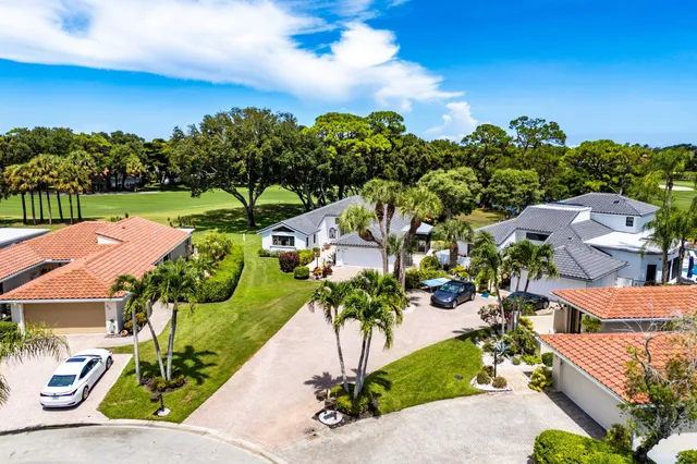 a view of a swimming pool with chairs in patio