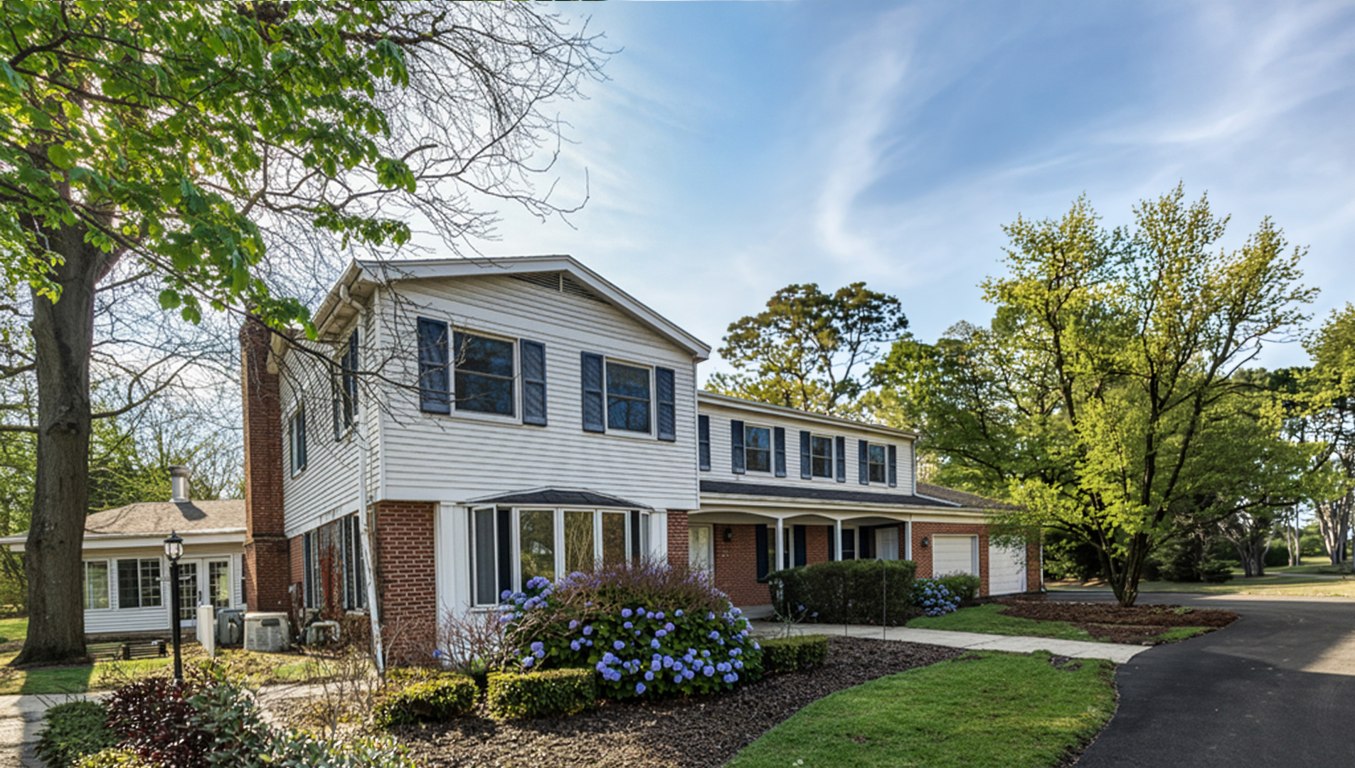 32-w050 Cedar Lane Wayne, IL 60184 - Photo 1 of 38 a front view of a house with a garden