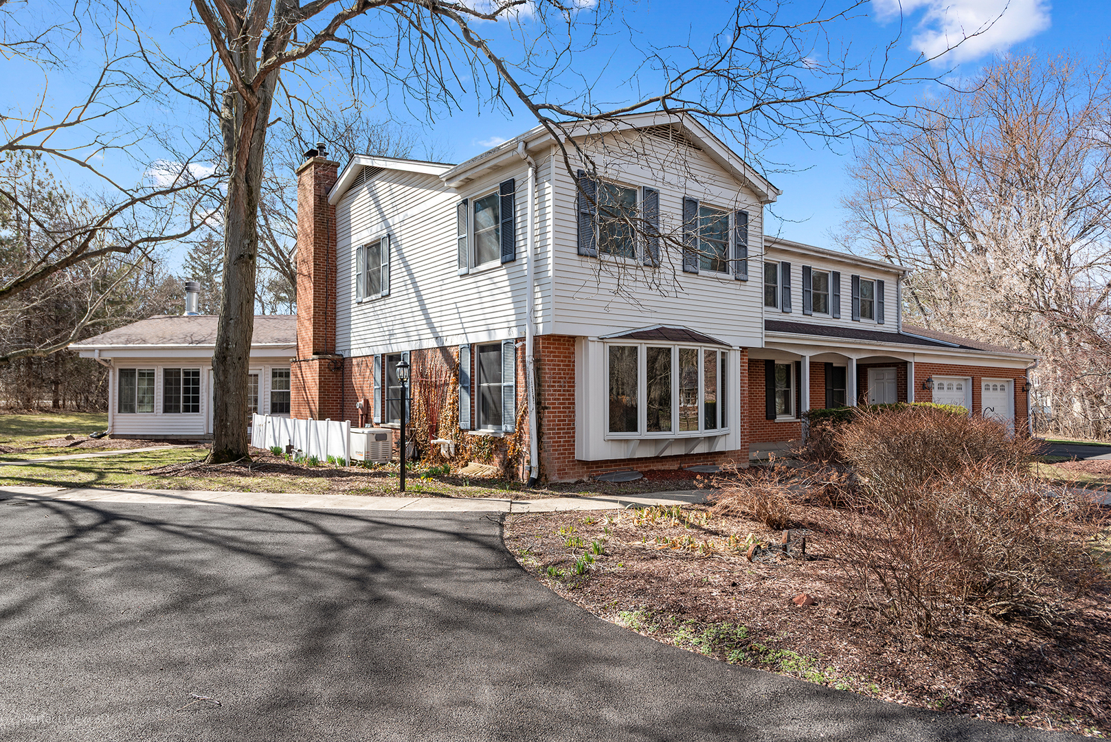 32-w050 Cedar Lane Wayne, IL 60184 - Photo 2 of 38 a front view of a house with a yard