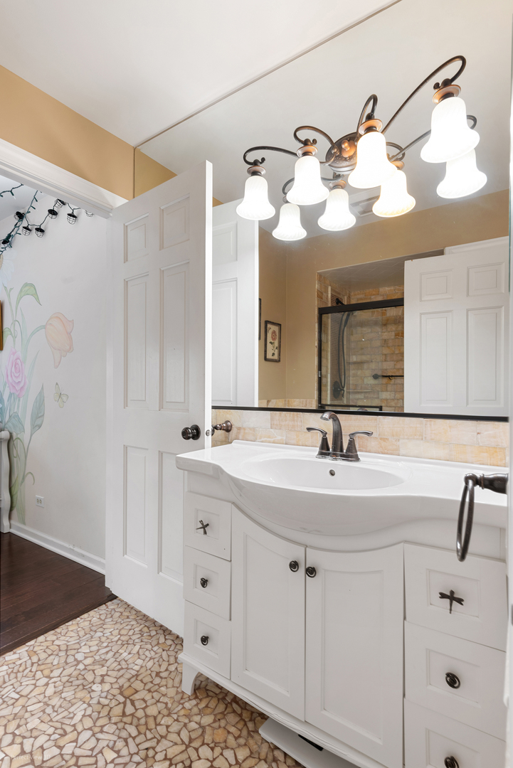 32-w050 Cedar Lane Wayne, IL 60184 - Photo 25 of 38 a bathroom with a sink vanity and mirror