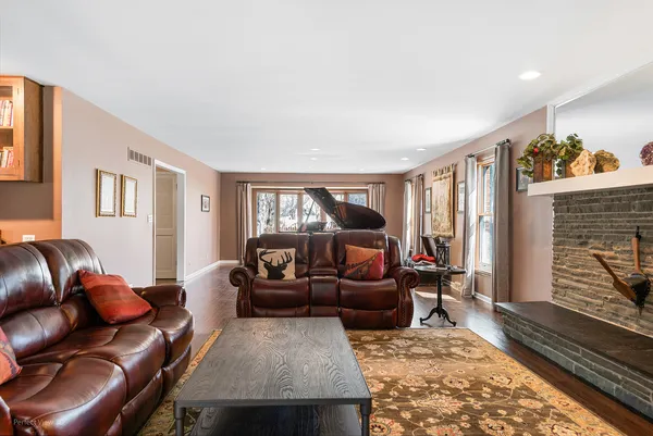 a living room with furniture fireplace and a window