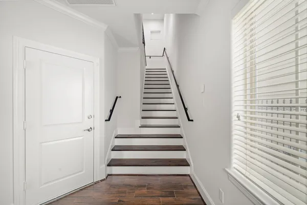 a view of entryway and hall with wooden floor