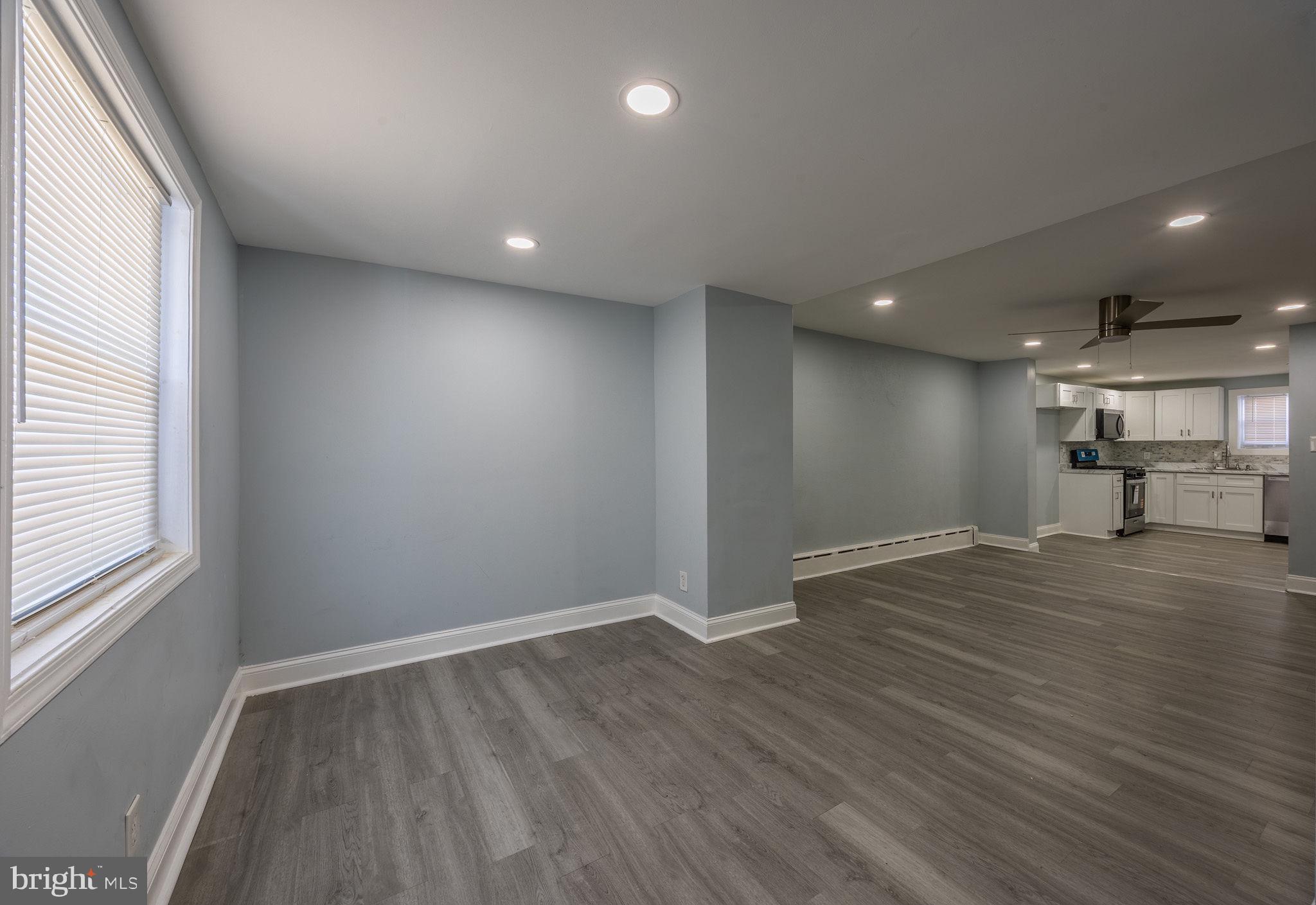 2403 South Edgewood Street Philadelphia, PA 19142 - Photo 11 of 31 an empty room with wooden floor and windows