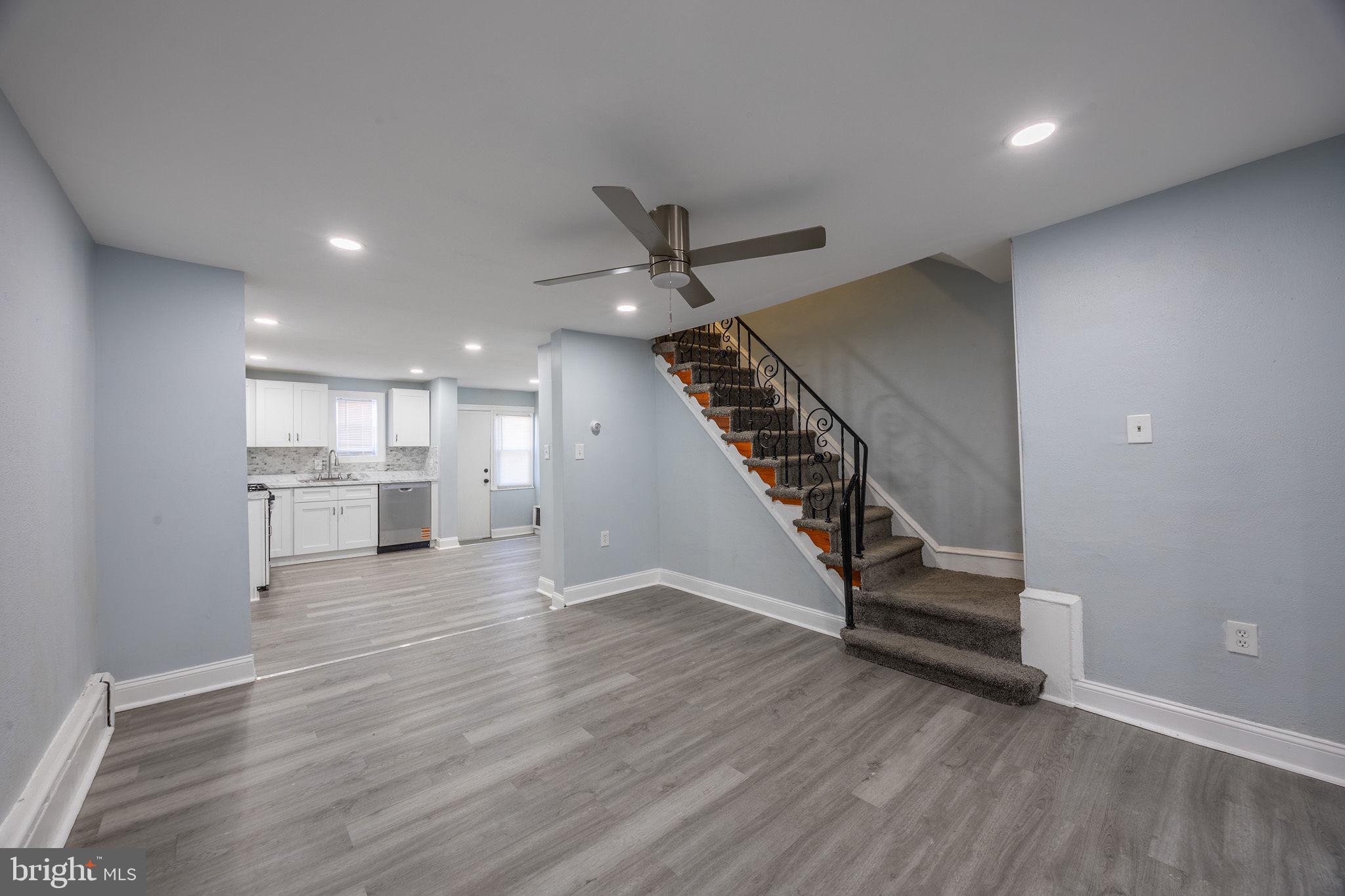 2403 South Edgewood Street Philadelphia, PA 19142 - Photo 8 of 31 an empty room with wooden floor and staircase