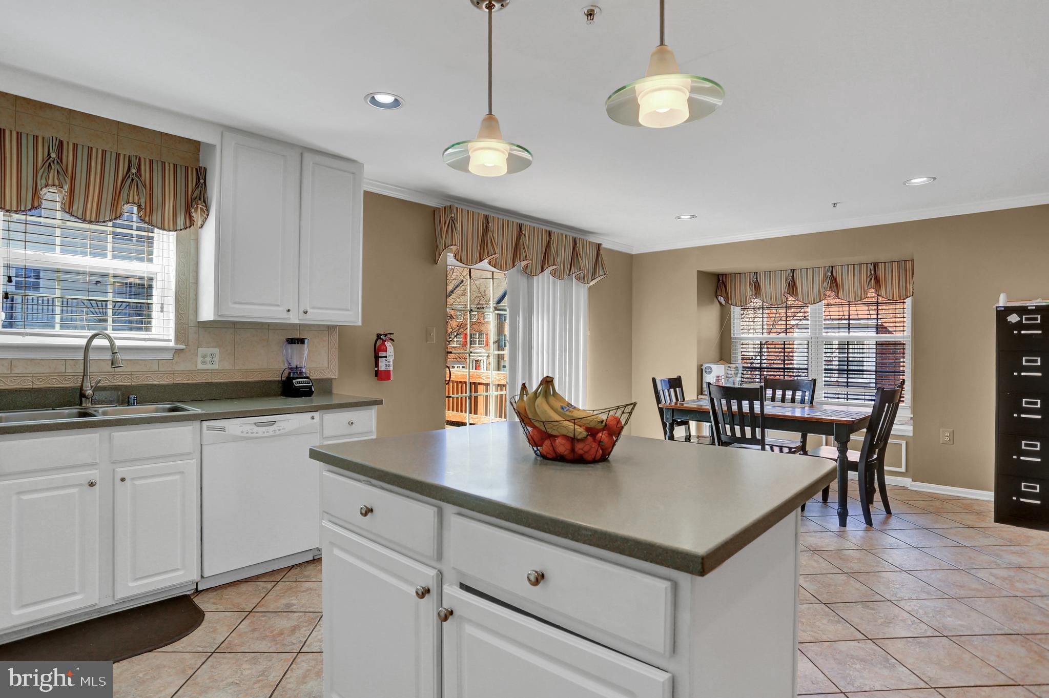 4712 Ashforth Way Owings Mills, MD 21117 - Photo 8 of 38 Corian Countertops. Pendant and recessed lighting.