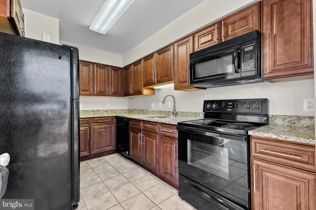 a kitchen with stainless steel appliances granite countertop a stove microwave and sink