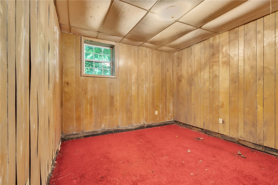 602 Harper Road Pendleton, SC 29670 - Photo 23 of 32 A windowed basement room with paneled walls awaits renovation.
