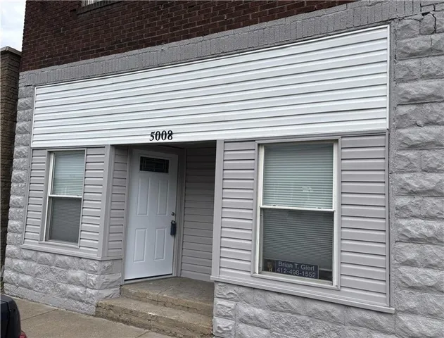 a view of a house that has a window and door