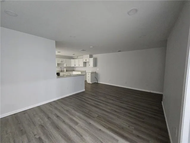 a view of a kitchen with wooden floor and a sink