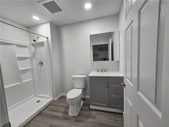 a bathroom with a toilet sink and shower