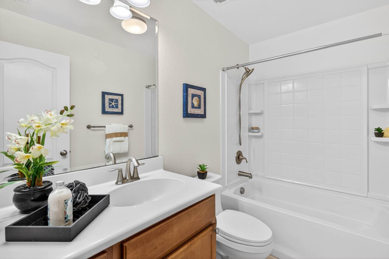 4712 Norris Canyon Road, Unit 104 San Ramon, CA 94583 - Photo 11 of 22 a bathroom with a granite countertop sink a toilet and shower