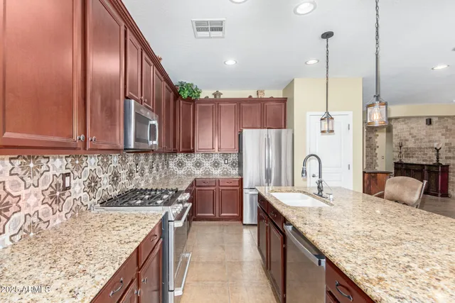 a kitchen with sink stove and living room view