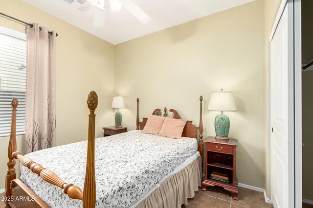 a bedroom with a bed table and a potted plant
