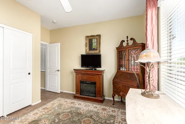 a view of an empty room with shelves and a window