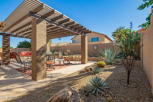 a view of a house with backyard and sitting area