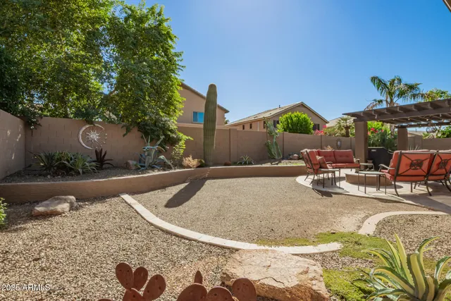 a view of a patio with table and chairs with wooden floor and fence