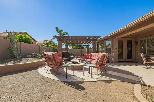 a view of a patio with table and chairs under an umbrella