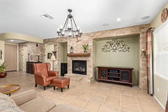 a kitchen with stainless steel appliances kitchen island granite countertop a refrigerator a stove and a wooden floors