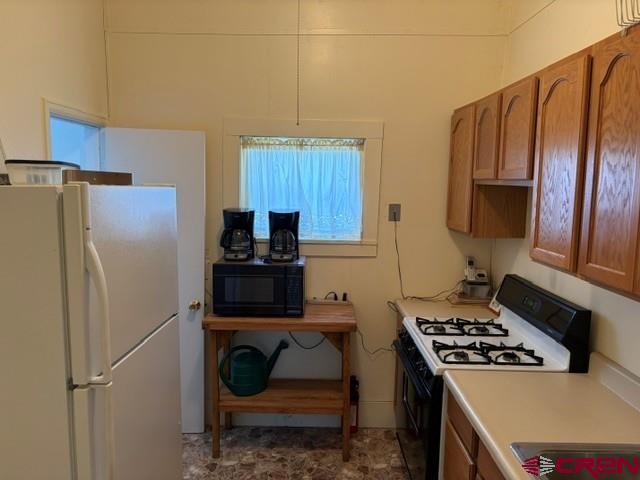 116 South Mary Street Ridgway, CO 81432 - Photo 8 of 23 a kitchen with granite countertop a refrigerator stove and sink