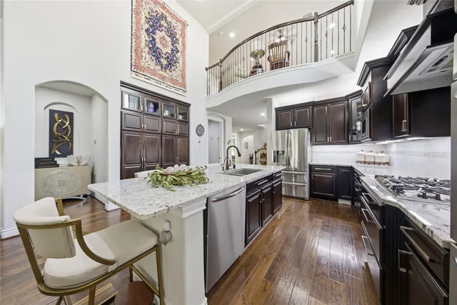 a spacious bedroom with a bed and a chandelier