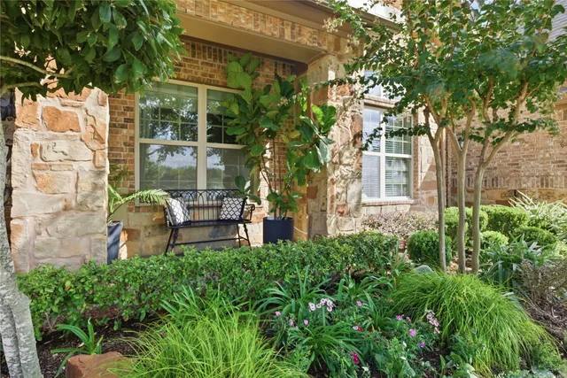 a view of a chair and table in backyard of the house