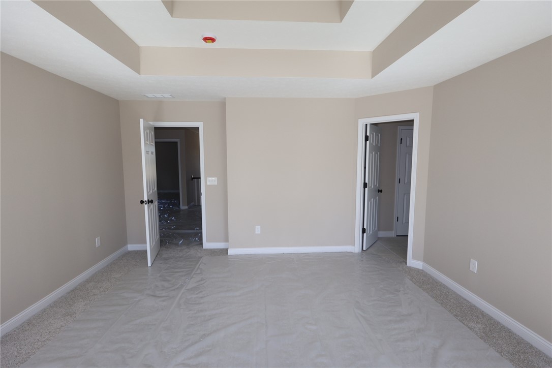 240 Tilly Court, Unit 5 Springboro, OH 45066 - Photo 20 of 26 This spacious bedroom offers a neutral palette and features a stylish tray ceiling.