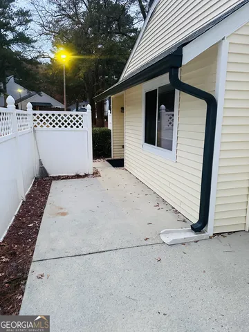 a view of a white house with a sink and a yard
