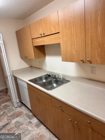a kitchen with a sink and a stove