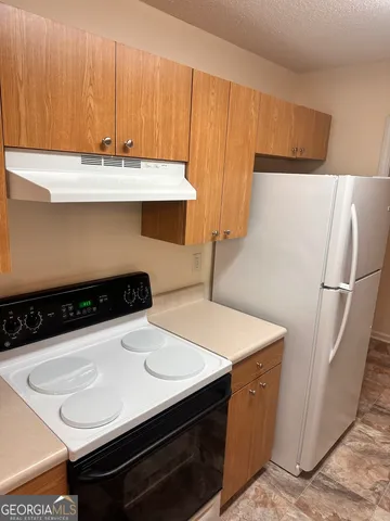 a kitchen with a sink and a refrigerator