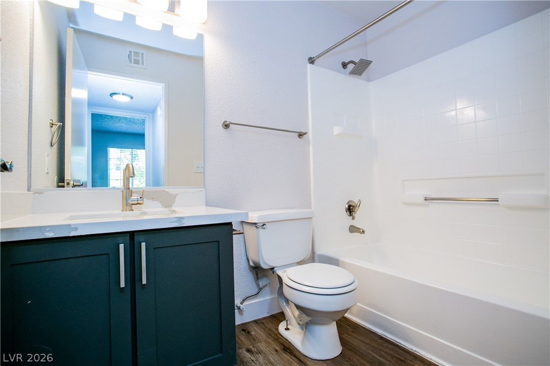 6750 Del Rey Avenue, Unit 108 Las Vegas, NV 89146 - Photo 5 of 11 This bright bathroom features a vanity, toilet, and a combination shower and tub.