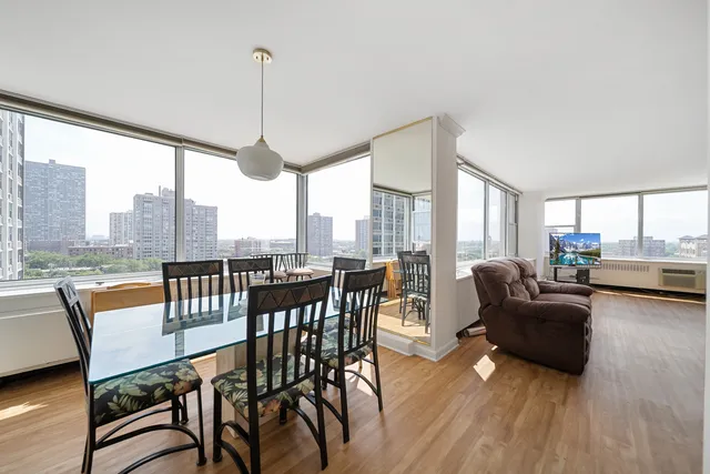 a view of a dining room with furniture window and wooden floor