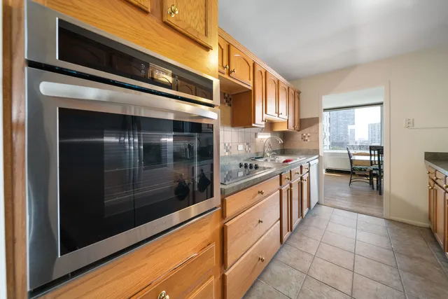 a kitchen with stainless steel appliances granite countertop a stove and a microwave