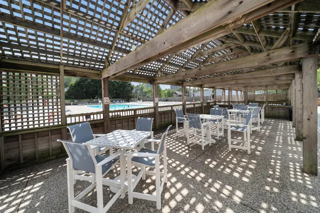 a view of a patio with table and chairs