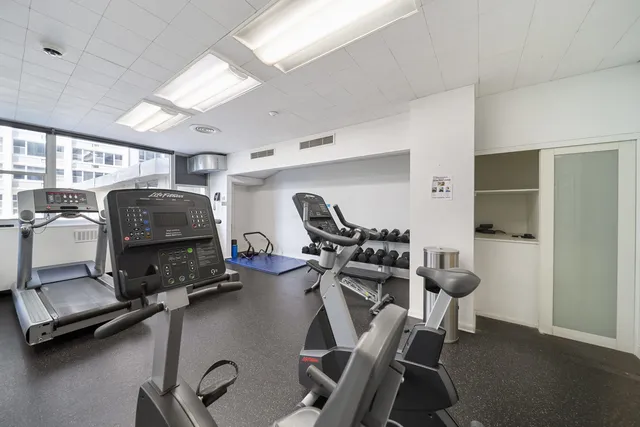 a room with gym equipment and windows
