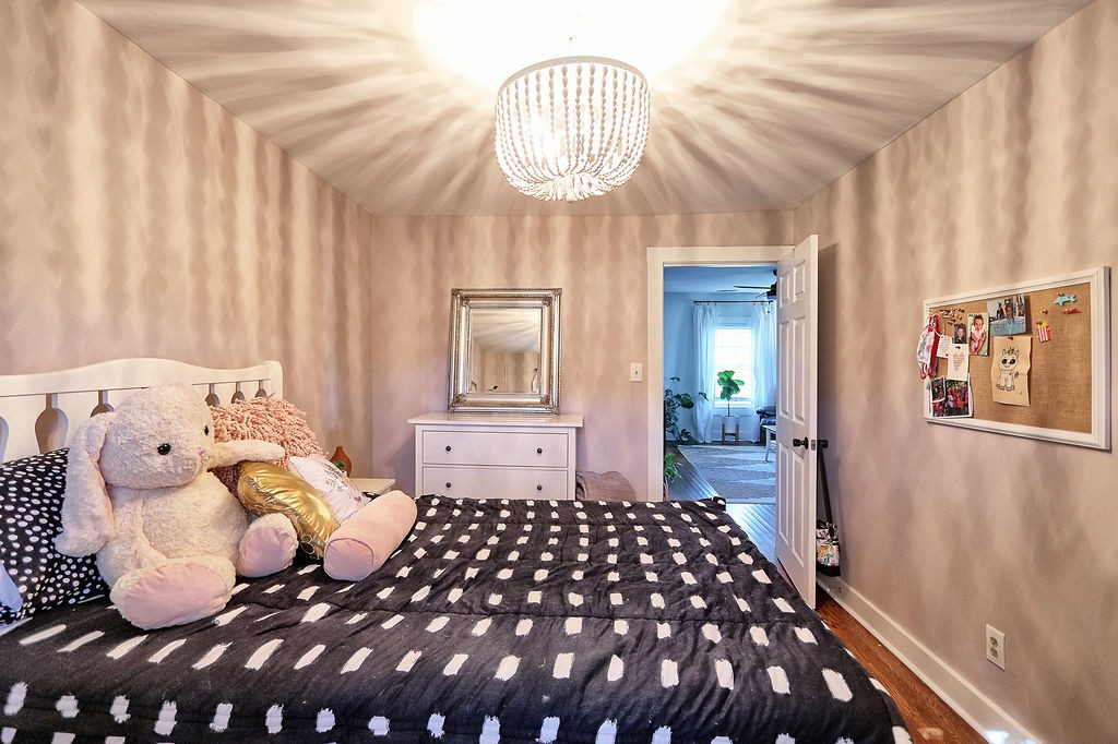 435 Canaan Road Columbia, TN 38401 - Photo 20 of 27 a bedroom with a large bed and a chandelier