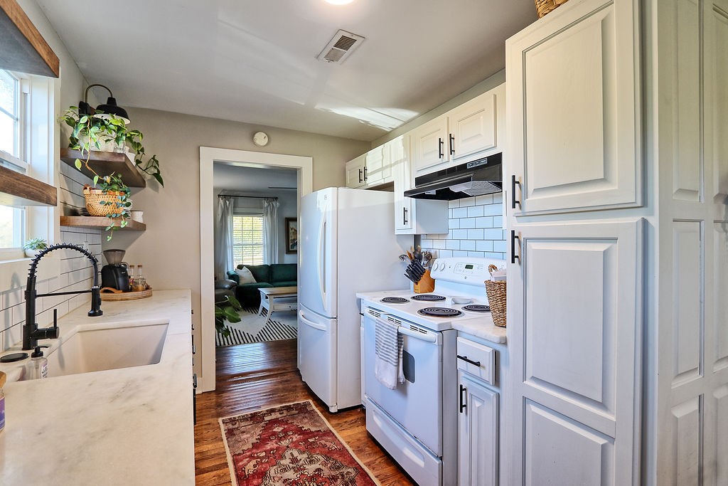 435 Canaan Road Columbia, TN 38401 - Photo 10 of 27 a kitchen with stainless steel appliances granite countertop a sink stove and refrigerator