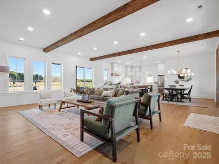 a living room with lots of furniture and a large window