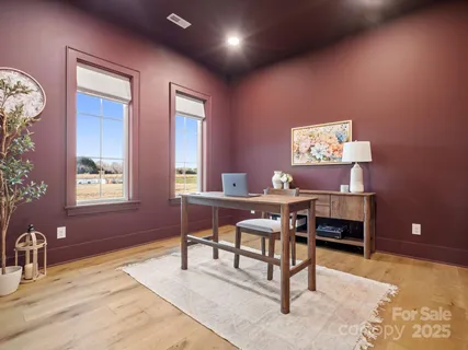 a work room with furniture and a potted plant