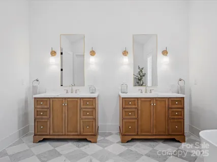 a spacious bathroom with a double vanity sink and a mirror