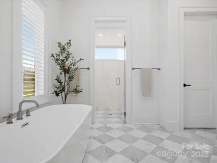a spacious bathroom with a bathtub and shower