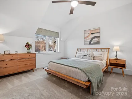 a bedroom with a bed dresser and window