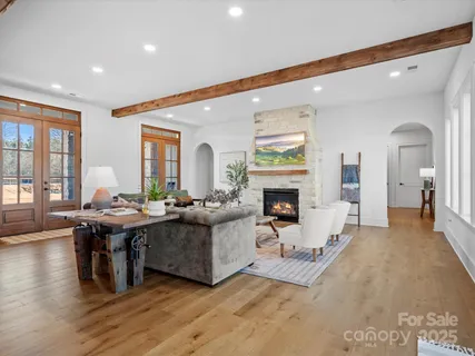 a living room with furniture a fireplace and a table