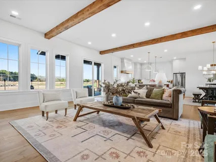 a living room with furniture wooden floor and a table