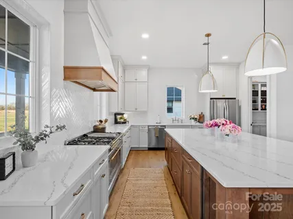 a kitchen with sink stove and cabinets