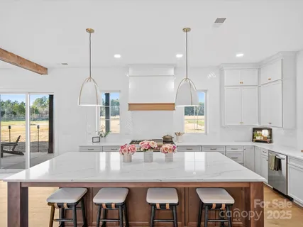 a kitchen with kitchen island stainless steel appliances and a table